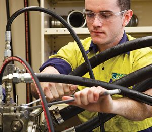 Man repairing hydraulic systems